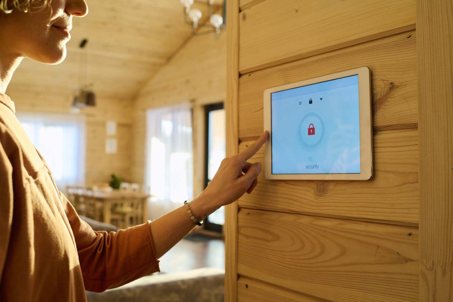 hand-of-young-woman-on-panel-of-alarm-system